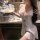 Woman in white sheer babydoll sleep dress with blue bows, holding dessert plate. pure & playful lingerie sleep set.