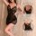 Woman modeling black lace sleep dress with sheer panels, adjustable straps, and back ties from pure & playful lingerie set.