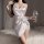 A woman elegantly poses in a luxurious white satin slip dress, featuring adjustable straps and a romantic design, perfect for...