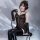 A woman models the pure & playful lingerie set, featuring a sparkling sheer mesh bodysuit with cutout straps and matching glo...