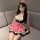 A woman models the pure & playful maid costume set, featuring a cute flirty outfit with a plaid skirt and bow headband, perfe...