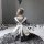 A girl wearing a black and white maid costume sits on a rug surrounded by balls, showcasing a cute japanese schoolgirl outfit...