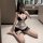 Woman posing in mirror wearing black and white maid lingerie set with lace trim, garter belt, and choker. pure & playful maid...