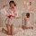 A woman models a playful strawberry-themed lingerie set inspired by japanese kimonos, featuring lace details and a bow design...