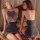 Two women modeling the pure & seductive busty secretary outfit, a sexy strapless bodycon nightclub set in shimmering gray.