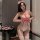Woman modeling red and white heart polka dot nurse bodysuit with lace trim, bow details, and matching headpiece.
