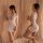 Woman wearing white lace bodycon dress with sheer sleeves, posing against soft draped curtains. perfect for nightclub or date...