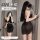 Woman modeling black lace bodysuit dress with french-style cutouts, wrap mini skirt, and neck tie detail.