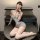 Woman wearing gray pure & seductive lace bodysuit with lace trim, high-waisted skirt, white thigh-highs, and blindfold — eleg...