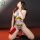 A woman poses wearing a gray bodysuit with fuck me text, fishnet stockings, and high heels, holding a red box labeled salt & ...