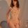 Woman wearing beige lace bodysuit with bows, open-crotch design, and sheer panels – sensual lingerie for curves.