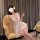 Woman in white lace chemise with deep v-neck and bow, sitting on yellow armchair. sheer sleep dress for women.