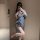 A woman poses in a light blue lace cheongsam dress, capturing a mirror selfie. the elegant design features a deep slit and de...