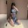 A woman poses in a blue lace cheongsam lingerie set, featuring a sheer design and elegant detailing, perfect for romantic dat...