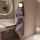 A woman poses in a bathroom wearing a light blue lace cheongsam lingerie set, featuring a high slit and elegant design, perfe...
