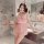 Woman in pink lace sleep dress with ruffles and bow, posing in marble bathroom. pure & seductive satin-blend nightgown with a...