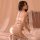 Woman wearing pure & seductive lace sleepwear set – sheer mesh babydoll nightgown with adjustable straps, posing on bed.