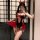Woman in mirror wearing black and red pure & seductive lingerie set with devil horns, bow details, and flowing robe.
