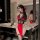 Woman modeling red and black lace cheongsam lingerie set in modern bathroom, featuring sheer panels and floral hair accessory...