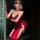 A woman poses elegantly in a red velvet qipao-style sleepwear set, featuring lace detailing and sheer gloves, embodying a ble...