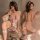 Model wearing pink feather lingerie set with cat ears, garter belt, and lace stockings for cosplay or date nights.
