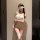 Woman in white polka dot lingerie set with lace blindfold and thigh-high stockings, pure & seductive q-qny style sleepwear.