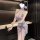 A woman models a sheer, floral-patterned qipao-style dress with a plunging neckline and thigh-high slit, perfect for evening ...