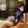 Woman in pure & seductive lingerie set - modest yet sexy secretary cosplay sleepwear with pencil skirt, posing on a couch.