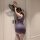 Woman in purple lace qqny silk-look cheongsam bodysuit with high-waisted pencil skirt, holding black fan against white door.