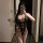 Woman wearing black lace lingerie set with intricate floral patterns and strappy details, showcasing the pure & seductive lin...