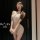 Woman wearing elegant beige pure & seductive lingerie set with lace details, blindfolded for a sexy secretary style look.