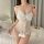 Woman wearing white lace lingerie set with bow detail, sheer bodysuit design for sleepwear or intimate occasions.