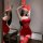 Woman wearing red lace bodysuit with bunny ears, sheer romantic sleepwear set with high-waisted skirt and thigh-high stocking...