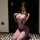 Woman wearing purple sheer mesh lingerie set, posing in mirror selfie for date night romance.