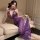 Woman in purple sheer bodysuit with lace trim and bow details, posing on sofa. pure & seductive lingerie set - sheer modest s...