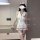 Woman wearing white nurse costume lingerie set with red cross hat, collar, and garter straps. pure & seductive no-remove desi...