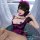 A woman models a black and purple nurse costume set, featuring lace details, ruffles, and fishnet stockings, perfect for roma...