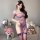 Woman modeling purple sheer one-shoulder qipao lingerie with lace trim, thigh-high stockings, and floral hair accessory.
