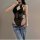 Woman wearing black lace halter bodysuit with jeans, showcasing flirty cropped design perfect for layering and body-conscious...
