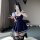 A person wearing a navy blue school uniform-style dress with white trim, featuring a pleated skirt, bunny ears, and a badge e...