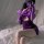 A woman poses in a purple velvet lingerie set, featuring a halter top and matching skirt, perfect for cosplay or sensual role...