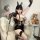Woman in black lace bodysuit with bunny ears, holding a whip, styled for role play.