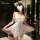 A woman models a delicate white lace sleep dress with cat ears, featuring a deep v-neckline and flowing tulle skirt, perfect ...