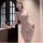 Woman wearing pure temptation lacy sheer nursing lace bra set with see-through mesh lingerie, holding wine glass by door.