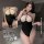 Model wearing black bodycon skirt sleepwear with sheer top and crisscross straps. pure temptation lingerie set, modest yet se...