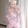 A woman poses in a pink floral kimono-style cosplay outfit, featuring a deep v neckline and large bow accents, perfect for fa...
