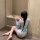 A woman sits on the floor wearing a delicate, floral-patterned kimono sleepwear set. the soft fabric features intricate desig...