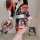 A woman models a vibrant floral japanese kimono-style lingerie set, featuring bold reds and blacks with elegant white accents...