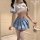 A stylish young woman models a blue and white schoolgirl uniform set, featuring a pleated skirt with silver stripes, a sailor...