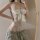 Woman wearing white lace lingerie set with bow detail, sheer sensual sleepwear for small bust, elegant erotic costume outfit.